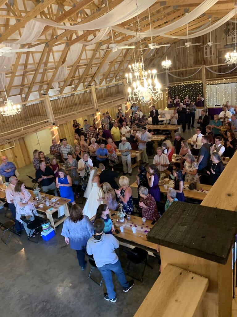 Newburgh Indiana Wedding DJ 11 Wedding ceremony in a rustic barn with guests gathered around a bride and groom