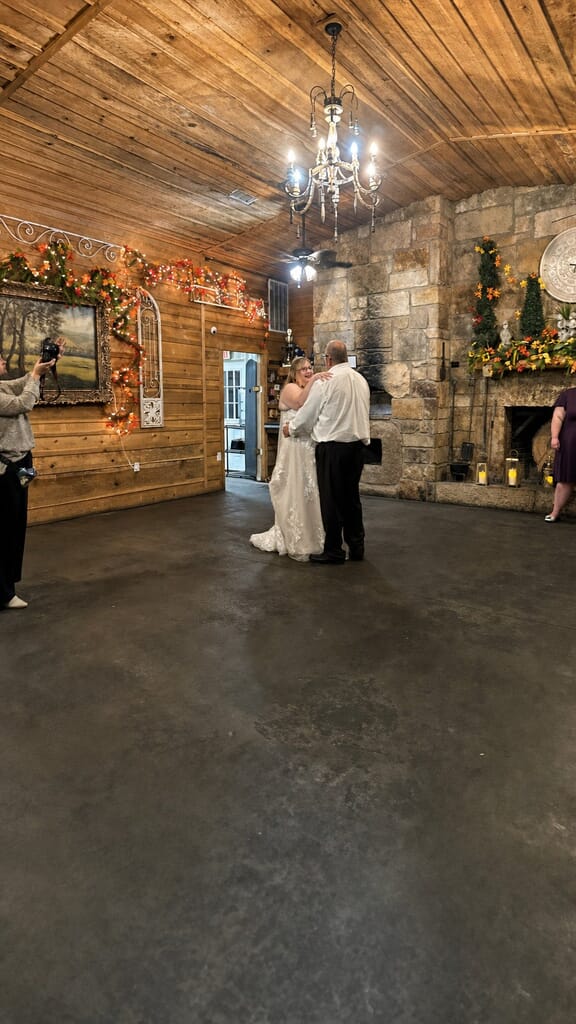 Wedding DJ Princeton Ky 12 Bride and groom dancing in a rustic room with wood-paneled walls and a stone fireplace