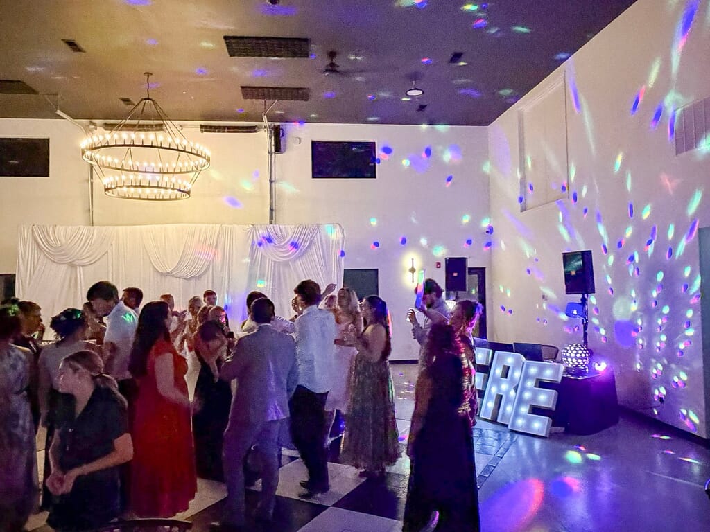 Gallery - Highbanks Wedding & Events Real Weddings 8 Guests dancing under the chandelier and colored lighting in the reception room at Highbanks.