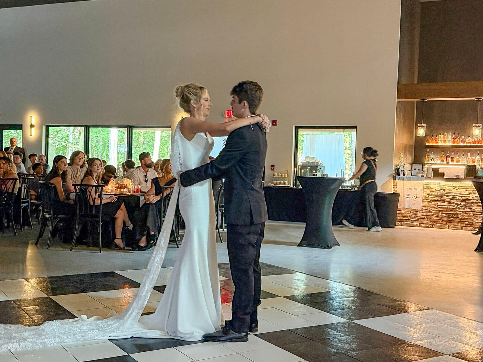 Bride and groom sharing a slow dance on the checkered floor at their Highbanks reception.