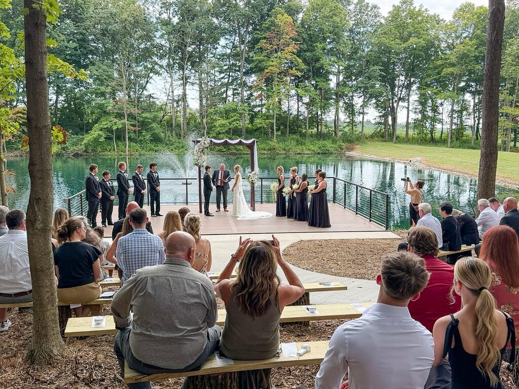 Gallery - Highbanks Wedding & Events Real Weddings 3 Outdoor waterside wedding ceremony on a wooden platform at Highbanks Wedding & Events in Petersburg, Indiana.